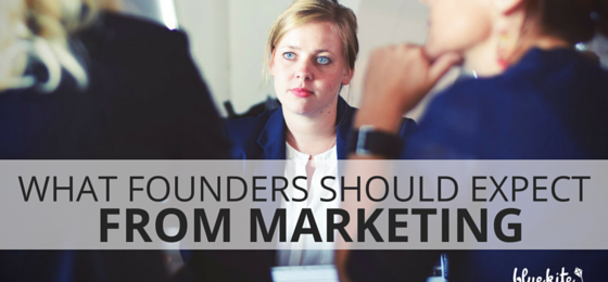 Startup founders sitting around a table discussing what role marketing should play in a successful startup.